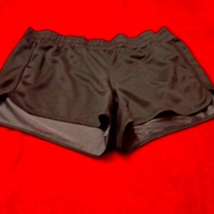 Black short silky gym shorts.